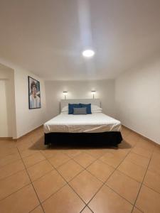 a bedroom with a bed and a tile floor at Caterina 70 in Naples