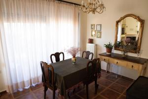 a dining room with a table and a mirror at The Early Bird - Cosy 2-Floor House with Garden in Alexandroupoli
