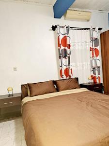 Postel nebo postele na pokoji v ubytování Chez Nofy Toamasina