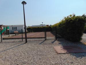 a playground with a gate and a street light at belle étoile in Biville-sur-Mer