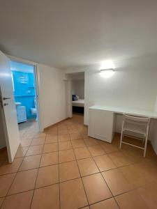an empty room with a table and a chair at Caterina 70 in Naples +15 photos