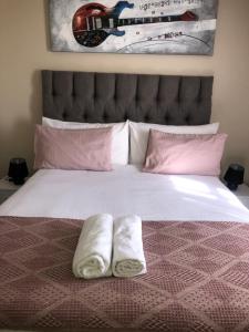 a bed with two towels sitting on top of it at Menlyn Bizcation Accommodation in Pretoria