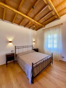 a large bedroom with a bed and a window at Podere Il Ritorno in Portoferraio