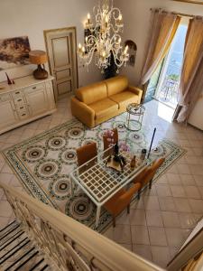 an aerial view of a living room with a table and chairs at Palazzo Rocco - Golden Suite - Praiano - Amalfi Coast in Praiano