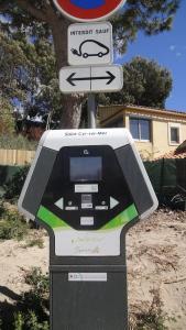 a parking meter with a car sign on top of it at Saint Cyr-sur-mer la Madrague les AÏgues Marines in Saint-Cyr-sur-Mer