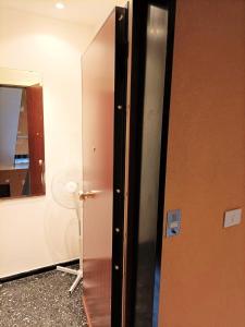 a bathroom with a door and a mirror at FRONTE del GOLF in Rapallo