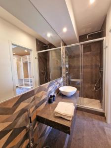 a bathroom with a sink and a shower at Mongibello Palace B&B in Mondello