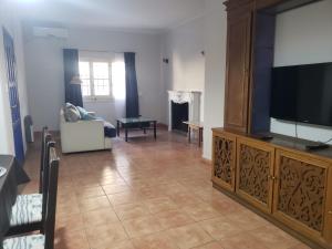 a living room with a large flat screen tv at Arístides Azul in Mendoza