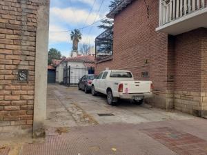 a white truck parked next to a brick building at Arístides Azul in Mendoza