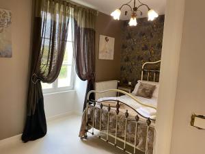 a bedroom with a bed and a window at Large French Farmhouse in Néré +16 photos