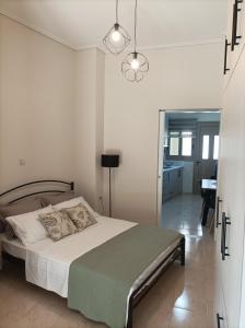 a bedroom with a large bed and a bathroom at Zeta ' s house in Nafpaktos