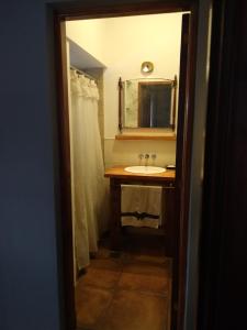 a bathroom with a sink and a mirror at Villa Escondida in Mar del Plata +22 photos
