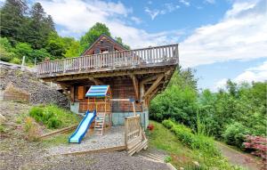 a tree house with a slide and a deck at 4 Bedroom Cozy Home In Mont-dore in Le Mont-Dore