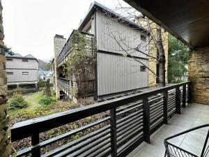 a balcony of a house with a wooden fence at Amplio departamento de diseño en el centro de SMA. 6C in San Martín de los Andes