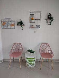 two chairs and a table in a room at Nel's House Villa Jacuzzi Sukabumi in Sukabumi +2 photos