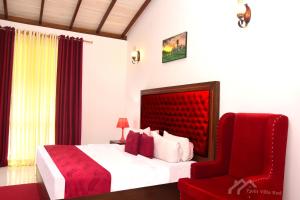 a bedroom with a red bed and a red chair at Twin Villa Red in Nuwara Eliya