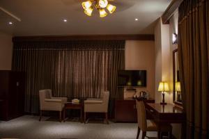 a hotel room with a table and chairs and a television at RATNA HOTEL in Birātnagar