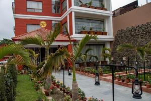 a building with palm trees in front of it at RATNA HOTEL in Birātnagar