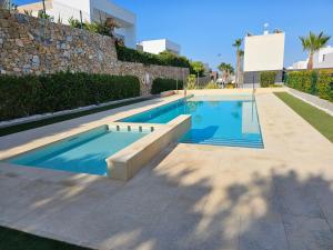 a swimming pool in the middle of a house at Casa Veran at La Finca Golf in Algorfa