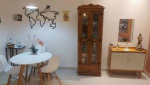 a dining room with a table and a map on the wall at Studio da Babi in Rio de Janeiro