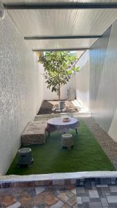 a patio with a table and a tree in it at Welcome to Big BL's house, Close to Tanger Med in Ksar es Sghir