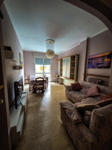 a living room with a couch and a table at Alloggio Rumore di Onde in Rapallo