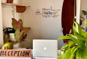 an apple laptop computer sitting on a desk with plants at Moana Beach House in Moalboal