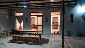 a patio with a wooden table and a bench at Indigo in Carpintería