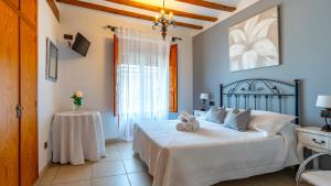 a bedroom with a bed with two towels on it at Hotel El Rullo in Vilafamés