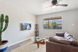 a living room with a couch and a ceiling fan at Viridian Biltmore Villa with Pool in Phoenix