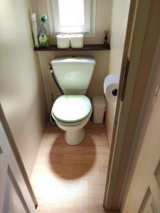 a small bathroom with a toilet and a window at Camping Urlaub Bredene Belgien in Bredene +18 photos