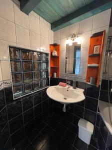 a bathroom with a sink and a mirror at Castle Chainbridge Apartment in Budapest