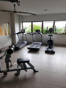a gym with several treadmills and machines in a room at Via Premiere Suite 710B in Rio de Janeiro