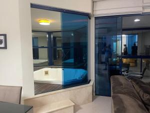 a room with a bath tub in a window at Rosa dos Ventos in Meia Praia