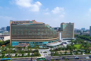 a large building in a city with a street at Narada Grand Hotel Zhejiang in Hangzhou