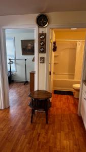 a room with a table and a clock on the wall at Beach Boutique Apartment in Old Orchard Beach