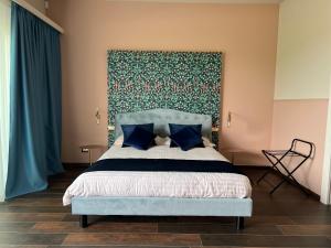 a bedroom with a bed with a large headboard at Le Finestre Sul Lago in Cesenatico