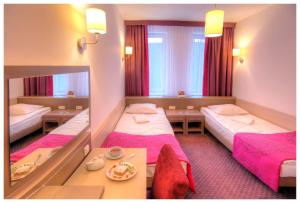 Postel nebo postele na pokoji v ubytování Arche Hotel Siedlce