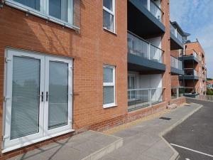 a brick building with white doors on the side of it at Admiral's View - Apartment 1 in Scarborough