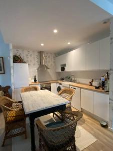 a kitchen with a table and chairs in it at Casa con jardin in Ribadesella