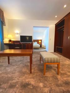 a living room with a table and a couch at Hotel Kaiserhof Deluxe in Lübeck