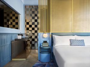 a bedroom with a bed and a table with a lamp at W Budapest in Budapest