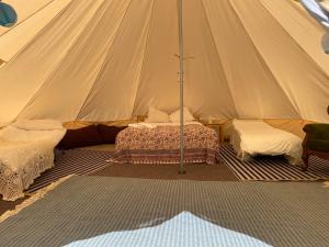 a tent with two beds in a room at Luxury glamping at Kipeni 