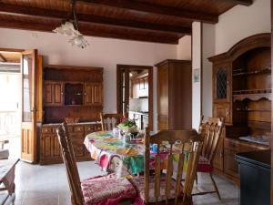 a kitchen with a table and chairs in a room at Casa vacanze BellaVista in Iglesias
