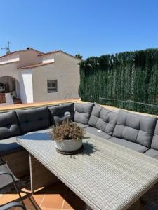 a couch sitting on a patio with a table at SANT MORI GRAN TERRASSA in Empuriabrava