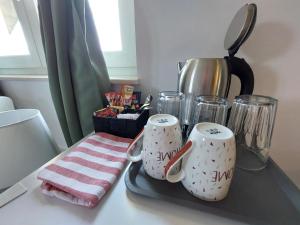 two mugs on a tray on a kitchen counter at Katarica in Korenica