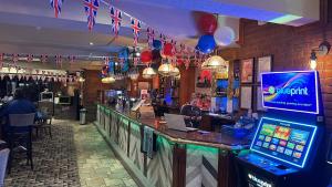 a bar in a restaurant with flags and balloons at The Grey Horse in Darlington