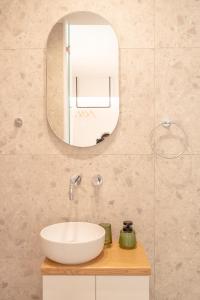 a bathroom with a white sink and a mirror at Sunset Luxury Villa in Akritokhórion