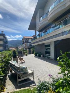 a large building with a patio with a couch on it at Bakio Beach House in Bakio +20 photos