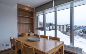 a dining room with a table and a large window at Snow Crystal in Kutchan